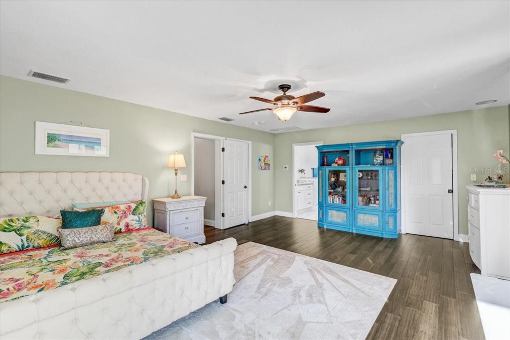 4710 Stearns Road Valrico, FL 33596 - Photo 32 of 63 a bedroom with a large bed and a chandelier