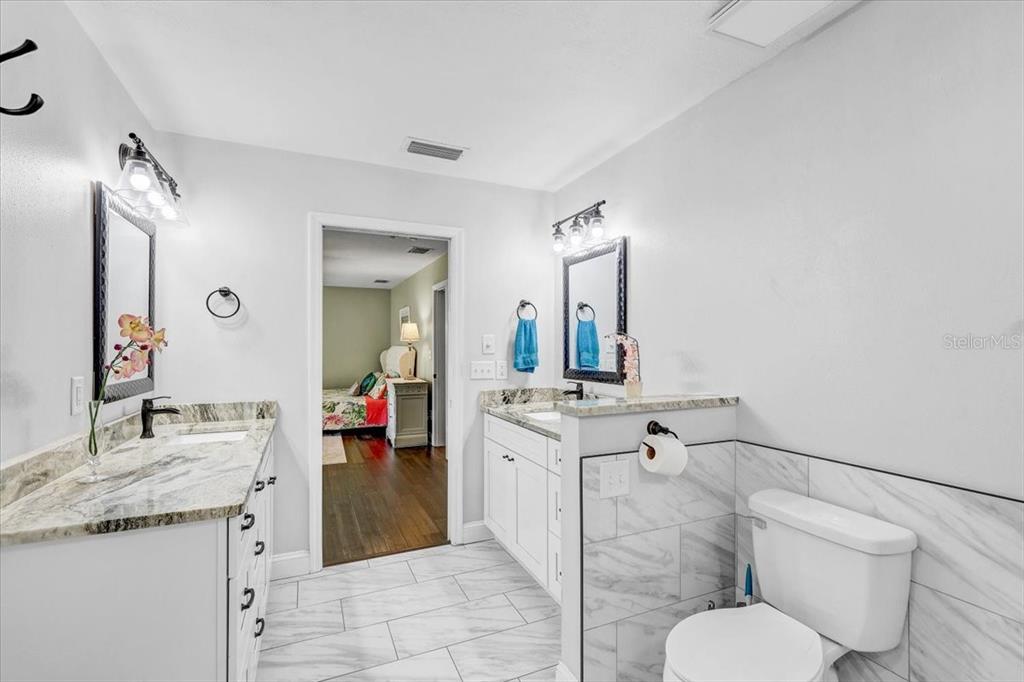 4710 Stearns Road Valrico, FL 33596 - Photo 35 of 63 a spacious bathroom with a granite countertop sink a toilet mirror and vanity