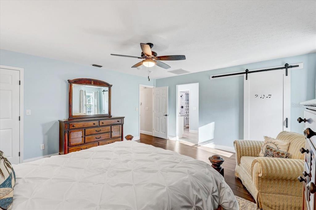 4710 Stearns Road Valrico, FL 33596 - Photo 43 of 63 a bedroom with a bed and a chandelier