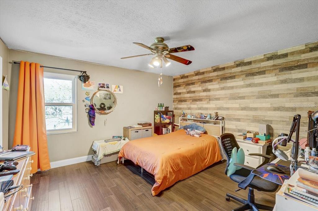 4710 Stearns Road Valrico, FL 33596 - Photo 47 of 63 a bed room with a bed and a chandelier