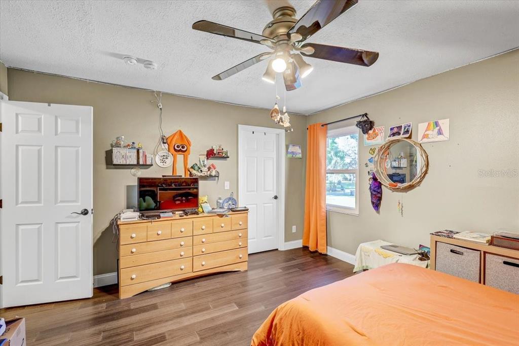 4710 Stearns Road Valrico, FL 33596 - Photo 49 of 63 a bedroom with a bed and wooden floor