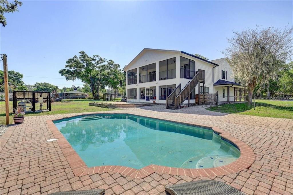 4710 Stearns Road Valrico, FL 33596 - Photo 57 of 63 a swimming pool with outdoor seating and yard