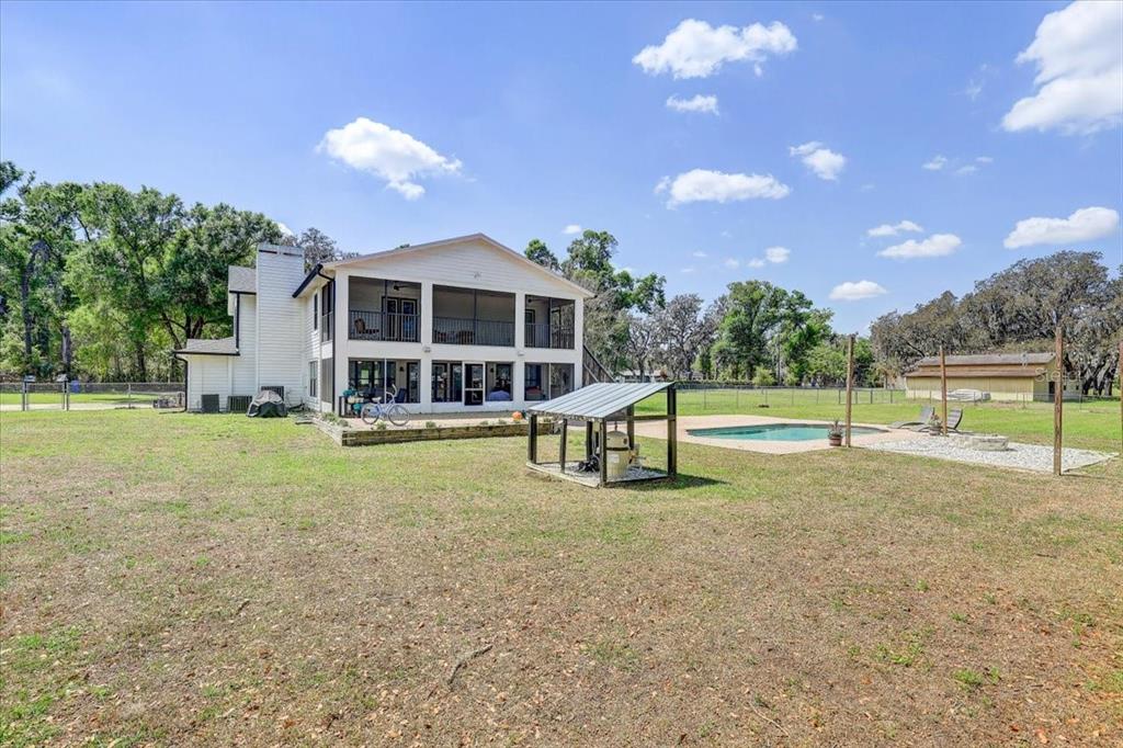 4710 Stearns Road Valrico, FL 33596 - Photo 58 of 63 a view of a house with swimming pool and a yard