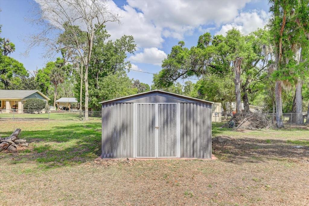4710 Stearns Road Valrico, FL 33596 - Photo 60 of 63 a view of a house with backyard and a tree