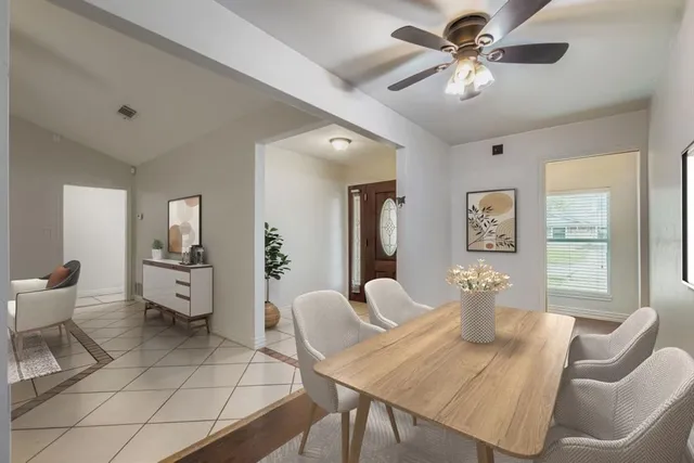 a living room with furniture a window and a chandelier