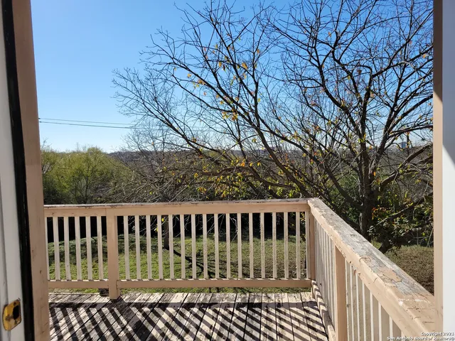 a view of balcony with wooden fence