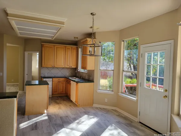 a kitchen with granite countertop a stove and a refrigerator