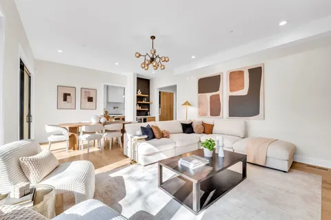 a living room with furniture and a chandelier