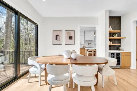 a view of a dining room with furniture window and wooden floor