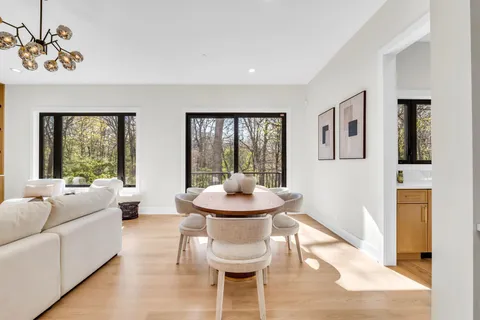 a living room with fireplace furniture and a floor to ceiling window