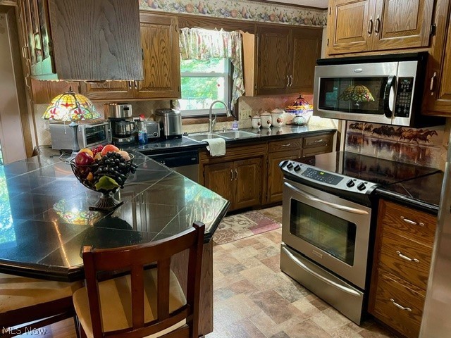 9692 Hess Mill Road Northeast Bolivar, OH 44612 - Photo 2 of 33 Kitchen featuring appliances with stainless steel finishes, backsplash, and sink
