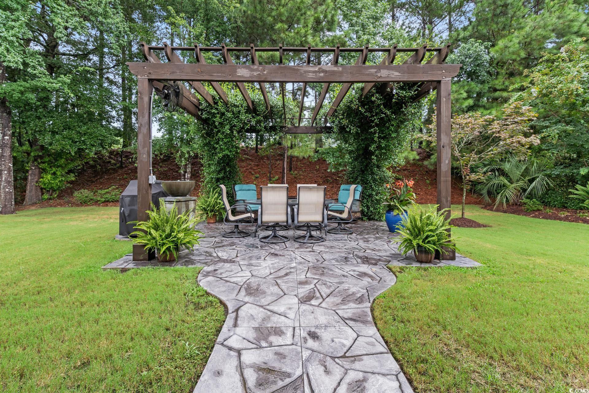 236 Chamberlin Road Myrtle Beach, SC 29588 - Photo 33 of 35 View of green lawn with a patio and a pergola