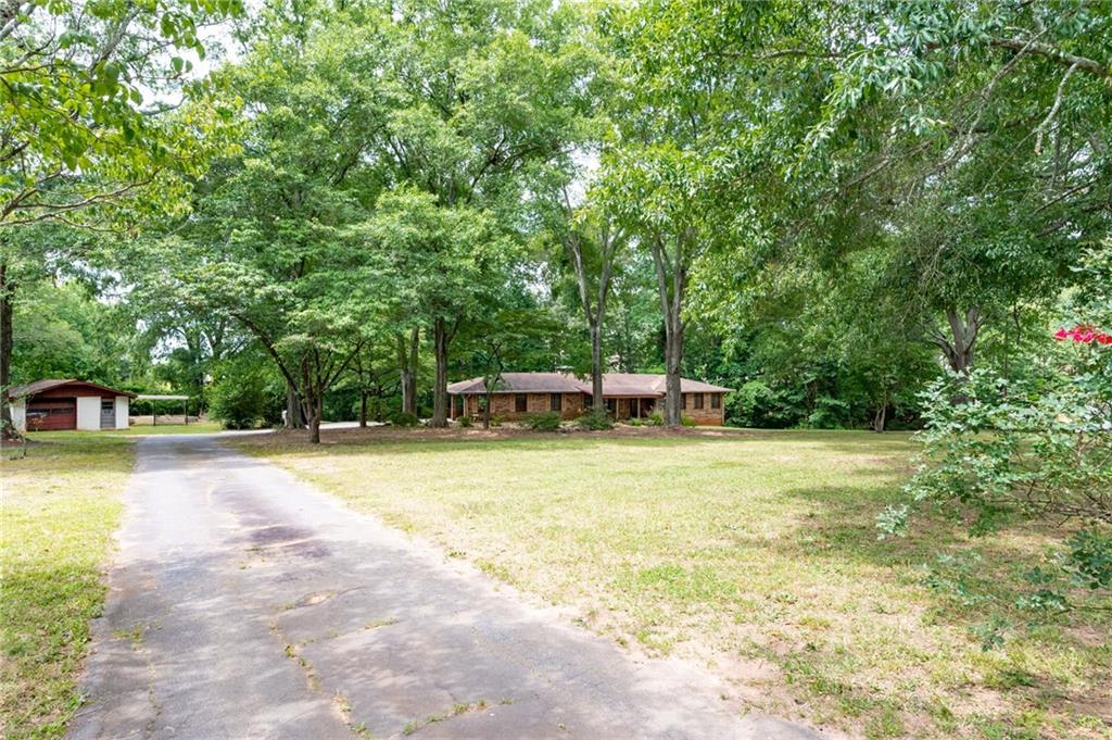 2421 Hurt Road Southwest Marietta, GA 30008 - Photo 1 of 1 a swimming pool with a trees