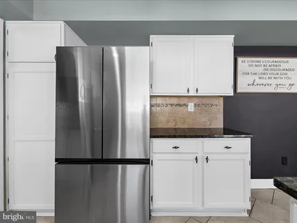 a white refrigerator freezer sitting in a kitchen