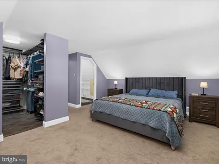 a bedroom with a bed and a view of bedroom