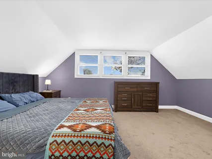 a bedroom with a bed and dresser