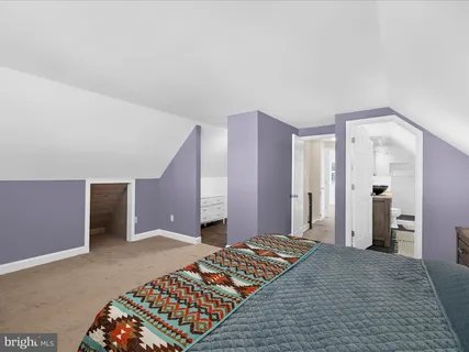 a bedroom with a bed and a walk in closet