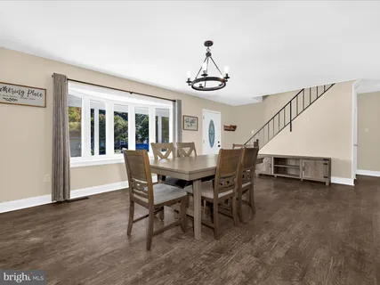 a view of a dining room with furniture wooden floor and a chandelier