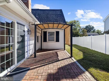 a view of a pathway of a house with a yard