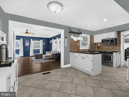 a large white kitchen with cabinets and stainless steel appliances