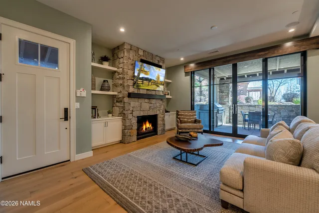 a living room with furniture a rug and a fireplace