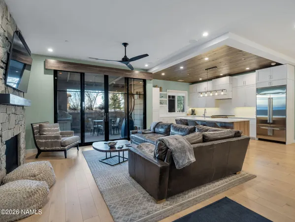 a living room with furniture and large windows