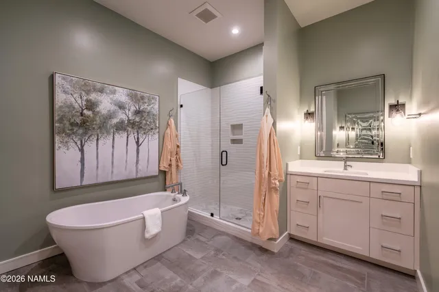 a bathroom with a bathtub and shower