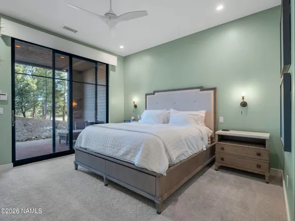 a spacious bedroom with a bed and large window