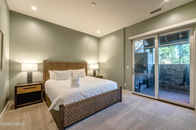 a bedroom with a bed and a lamp