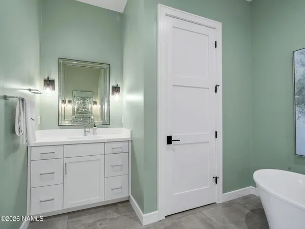 a spacious bathroom with a granite countertop sink a toilet and a mirror
