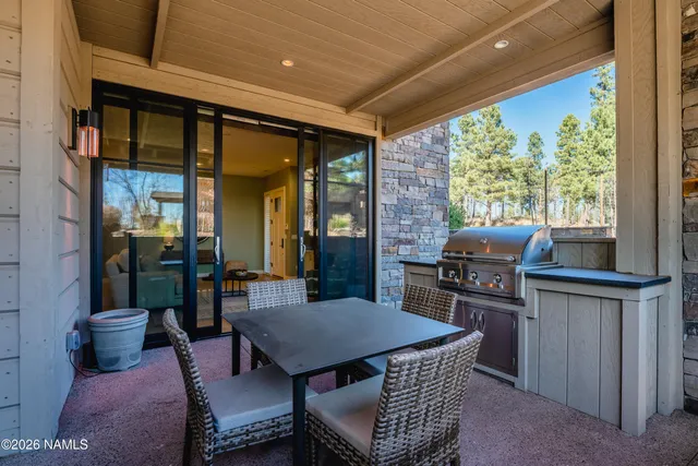 a dining room with furniture and a floor to ceiling window