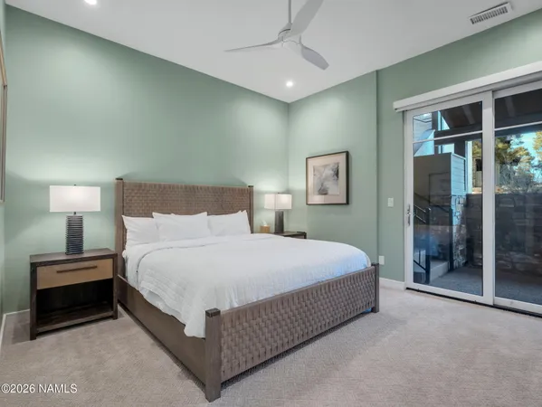 a bedroom with a bed and a lamp