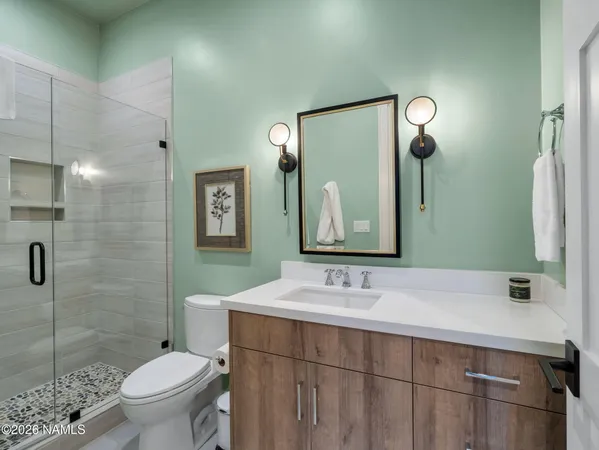 a bathroom with a sink toilet and shower