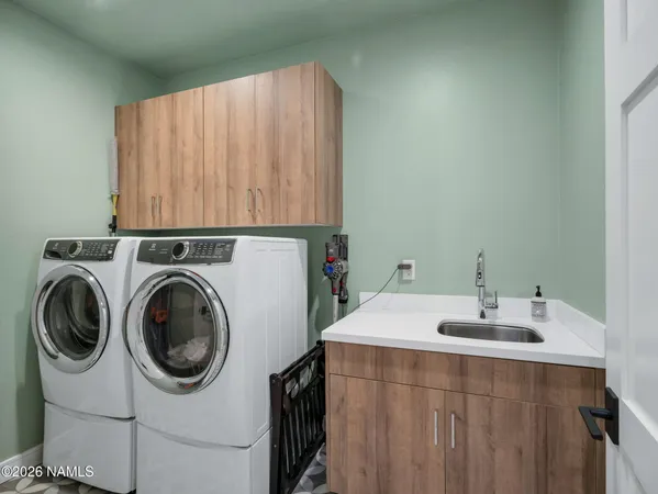 a bathroom with a sink and a washer dryer