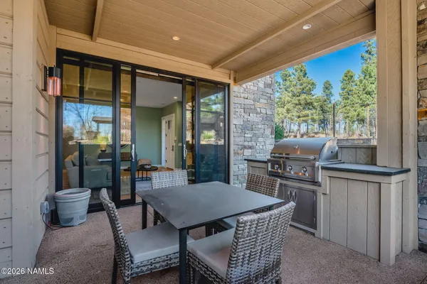a dining room with furniture and a floor to ceiling window