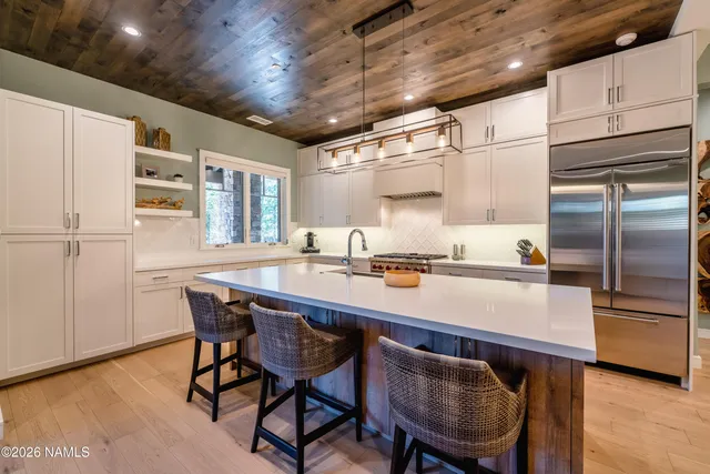 a kitchen with a table chairs and refrigerator