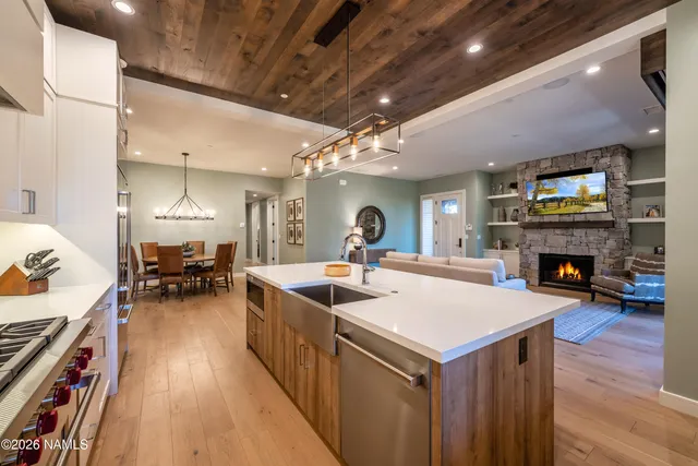 a kitchen with a stove and a wooden floor