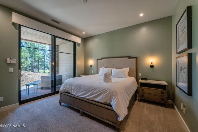 a spacious bedroom with a bed and large window