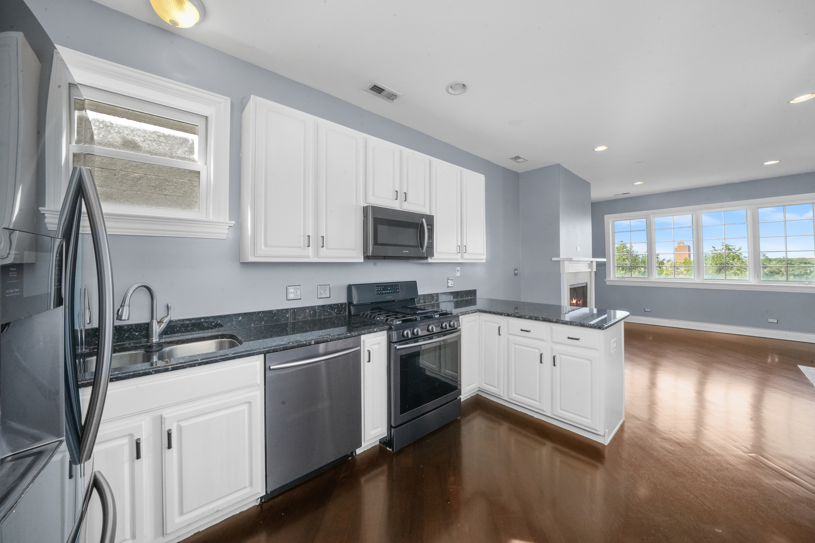 2503 West Harrison Street, Unit 4 Chicago, IL 60612 - Photo 12 of 31 a kitchen with a sink stove and cabinets