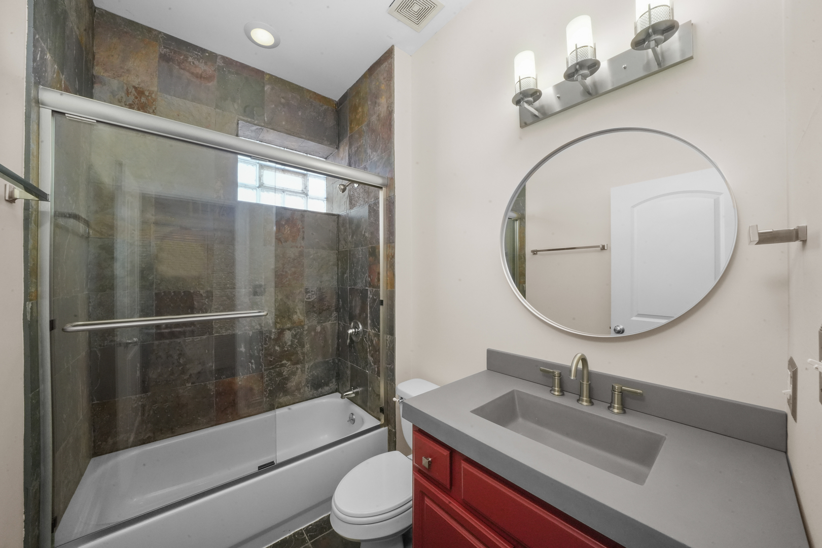 2503 West Harrison Street, Unit 4 Chicago, IL 60612 - Photo 14 of 31 a bathroom with a sink a toilet and a mirror