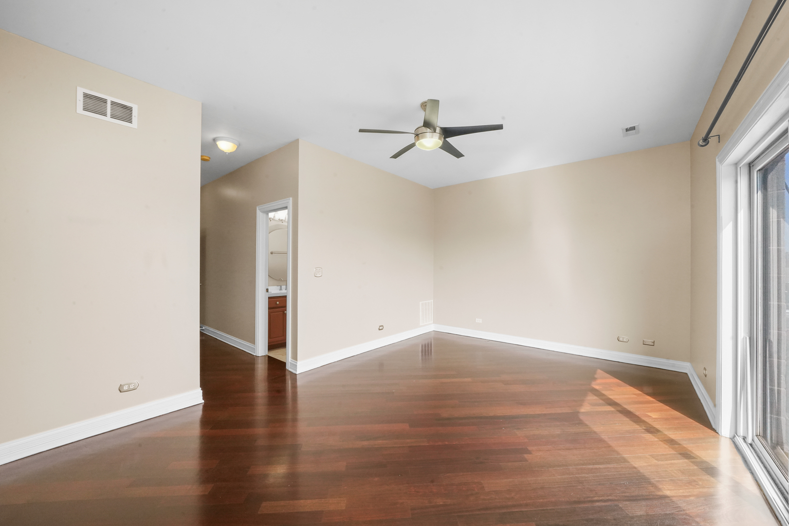 2503 West Harrison Street, Unit 4 Chicago, IL 60612 - Photo 17 of 31 a view of empty room with wooden floor and fan