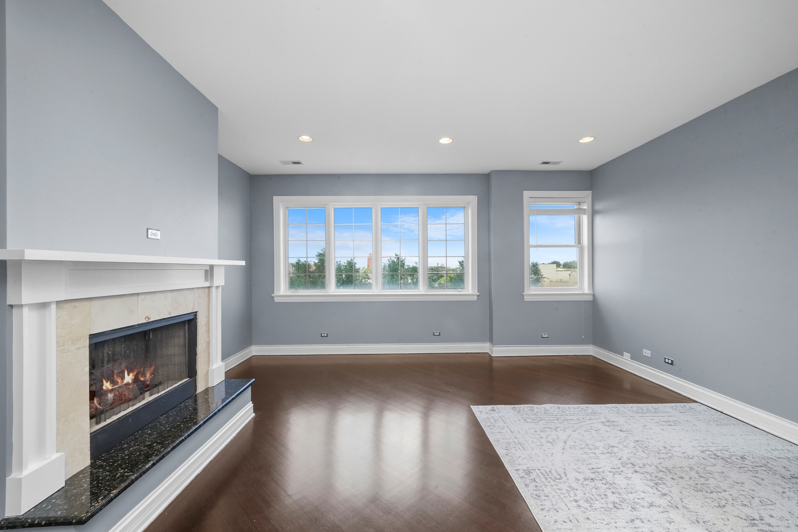 2503 West Harrison Street, Unit 4 Chicago, IL 60612 - Photo 6 of 31 an empty room with windows and fireplace