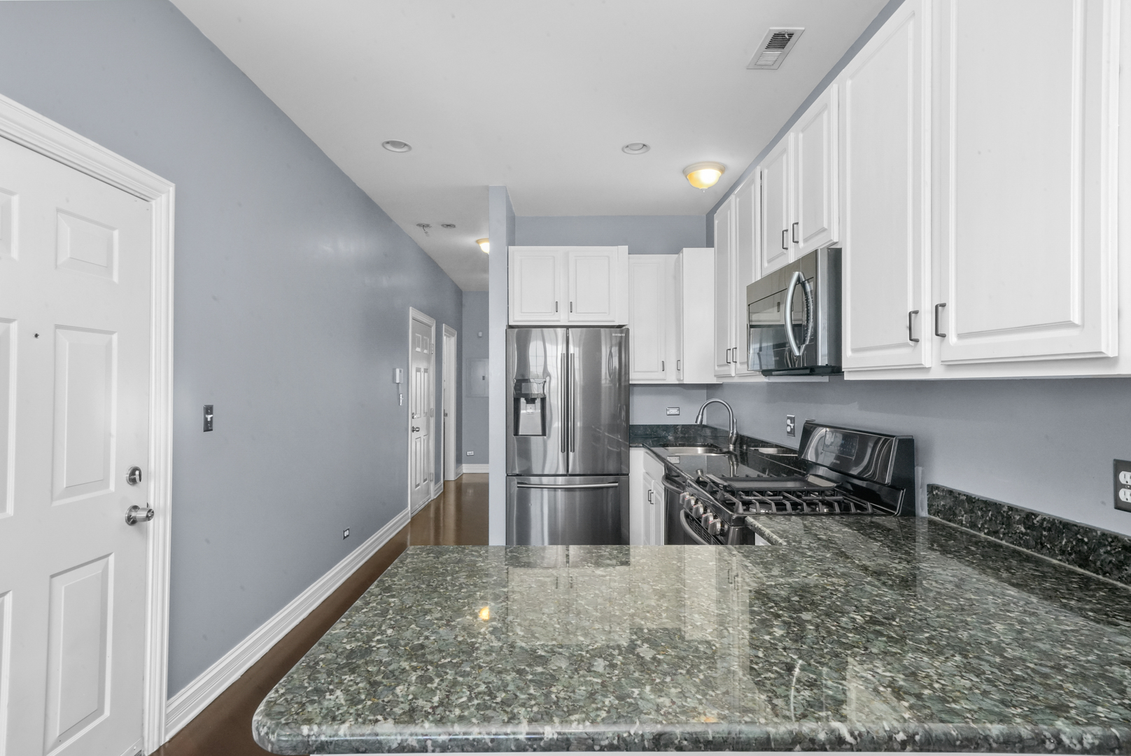 2503 West Harrison Street, Unit 4 Chicago, IL 60612 - Photo 9 of 31 a kitchen with stainless steel appliances granite countertop a refrigerator stove microwave and sink