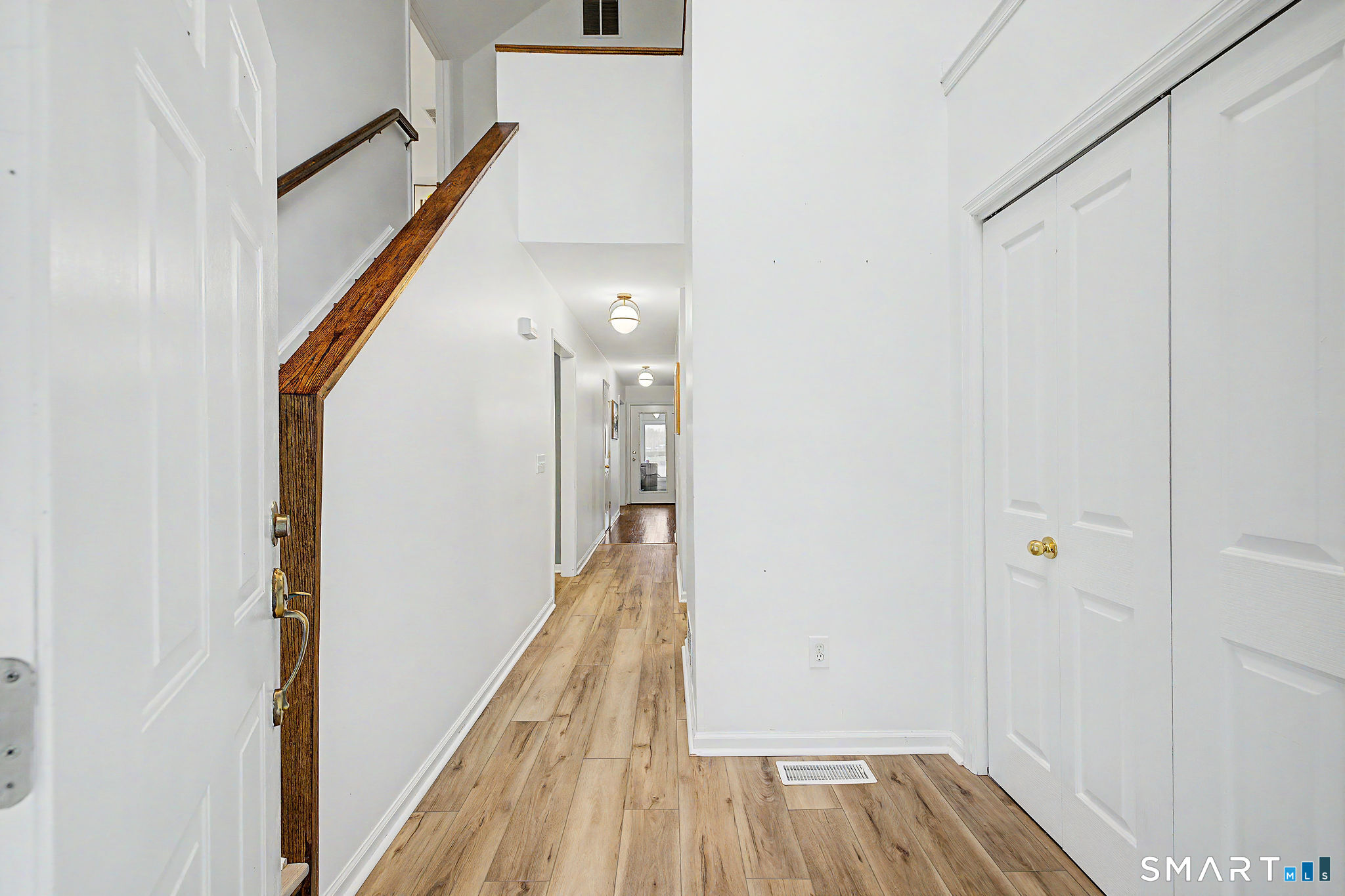 14 Shore Road Danbury, CT 06811 - Photo 9 of 30 a view of a hallway with wooden floor and staircase