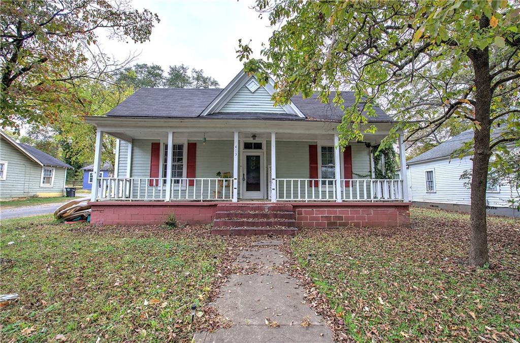 a front view of a house with yard and green space