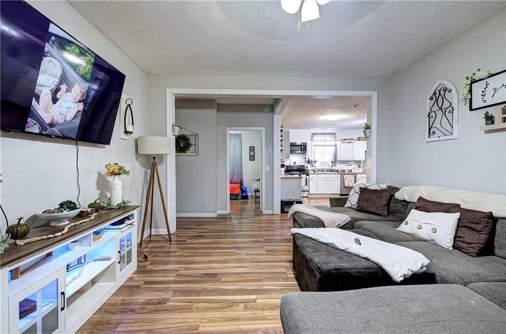413 Calhoun Avenue Northeast Rome, GA 30161 - Photo 14 of 27 a living room with furniture and a flat screen tv