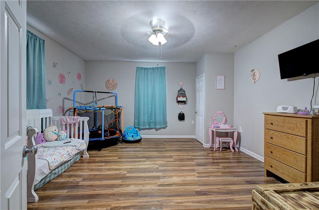 413 Calhoun Avenue Northeast Rome, GA 30161 - Photo 16 of 27 a bedroom with furniture and a flat screen tv