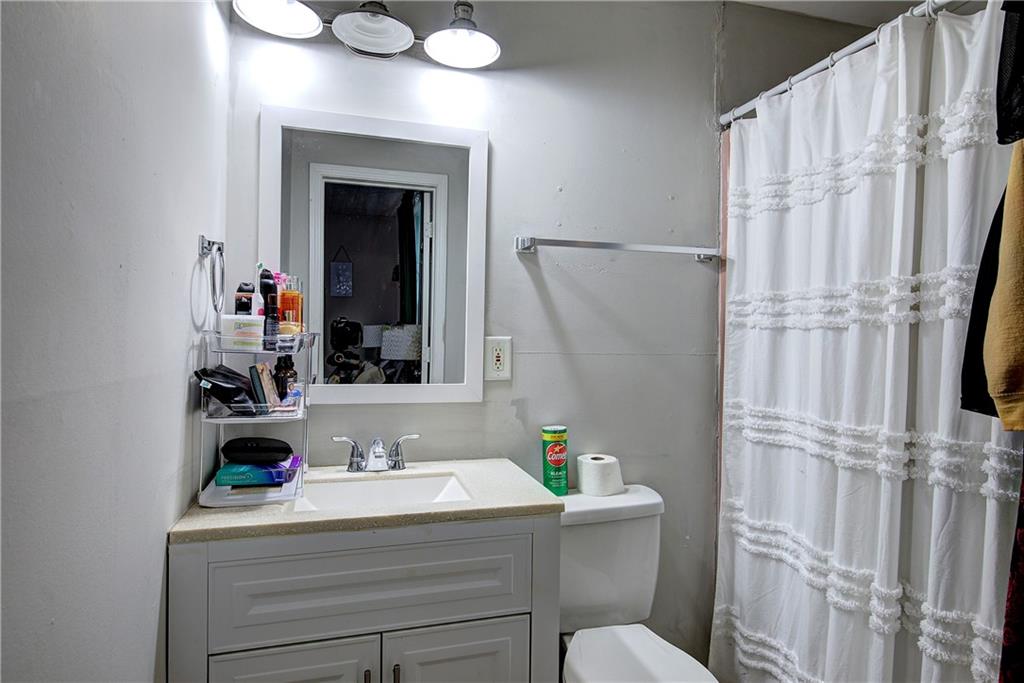 413 Calhoun Avenue Northeast Rome, GA 30161 - Photo 17 of 27 a bathroom with a sink vanity mirror and toilet