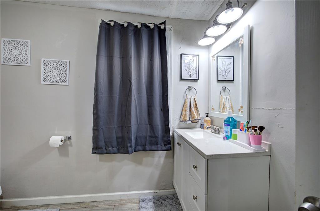 413 Calhoun Avenue Northeast Rome, GA 30161 - Photo 19 of 27 a bathroom with a sink vanity and a mirror