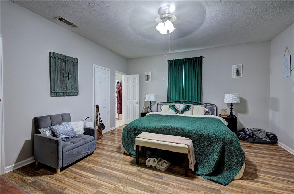 413 Calhoun Avenue Northeast Rome, GA 30161 - Photo 21 of 27 a living room with furniture and a wooden floor